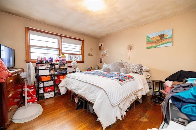 bedroom with dark hardwood / wood-style flooring