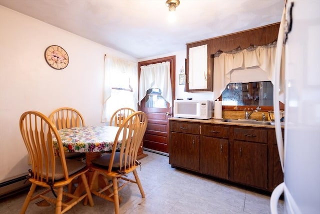 dining room with sink and baseboard heating