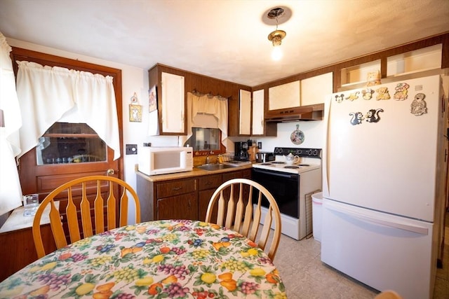 kitchen featuring sink and white appliances