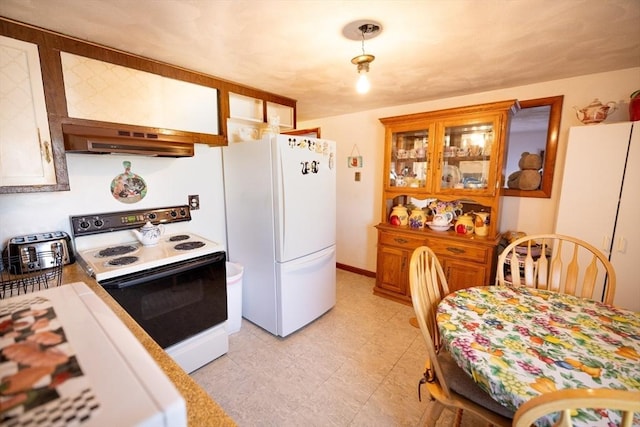 kitchen featuring white appliances and range hood