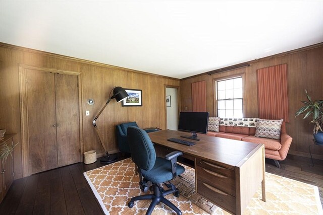 office space with hardwood / wood-style floors, wooden walls, and ornamental molding