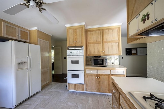 kitchen with white appliances, a ceiling fan, light countertops, ornamental molding, and backsplash