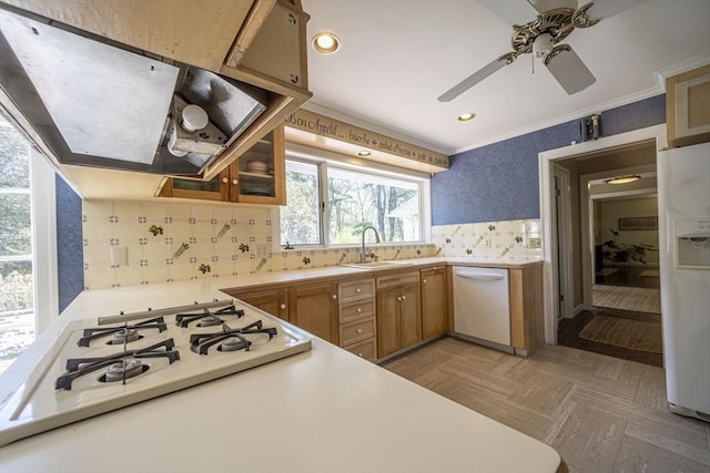 kitchen featuring white appliances, ventilation hood, a sink, decorative backsplash, and light countertops