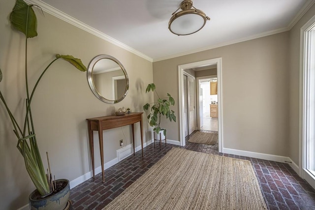 foyer with brick flooring, baseboards, and ornamental molding