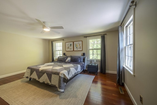 bedroom with dark wood-style flooring, baseboards, and ceiling fan