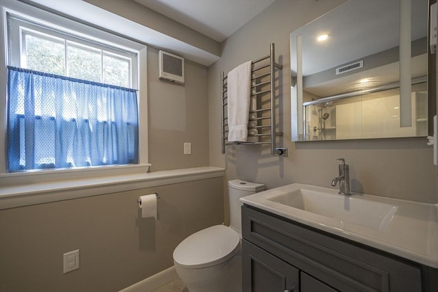 bathroom with toilet, a shower with shower door, vanity, a towel warming rack, and radiator