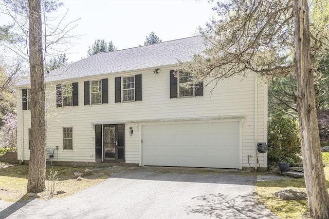colonial home with driveway and an attached garage