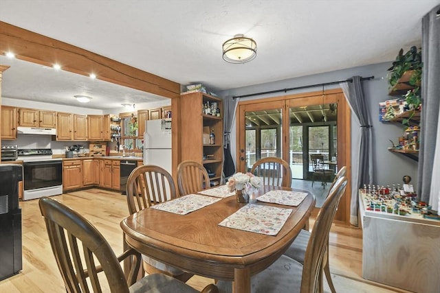 dining room with light wood-type flooring and sink