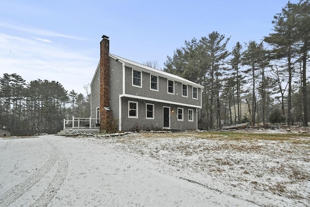 colonial-style house with a wooden deck