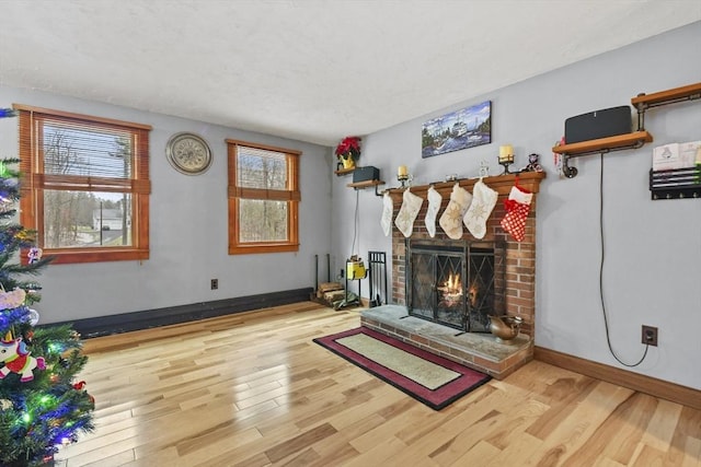 interior space featuring hardwood / wood-style flooring and a brick fireplace