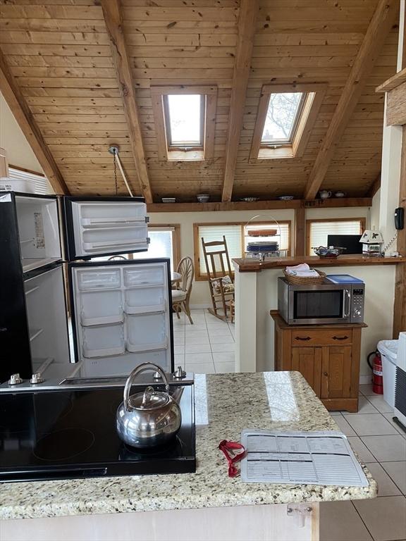 40 Provincetown View Rd, Plymouth, MA 02360 - kitchen with wooden ceiling, light tile patterned flooring, and vaulted ceiling with skylight