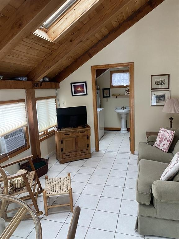 40 Provincetown View Rd, Plymouth, MA 02360 - tiled living room with vaulted ceiling with skylight, wood ceiling, and cooling unit