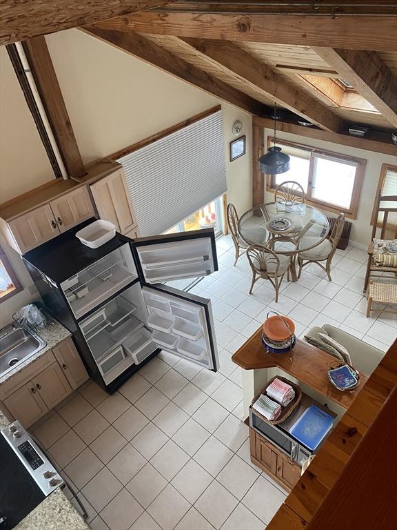 40 Provincetown View Rd, Plymouth, MA 02360 - kitchen with light tile patterned floors, sink, and vaulted ceiling with beams