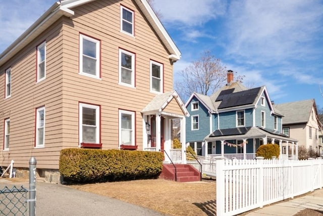 view of front of home featuring fence and a residential view