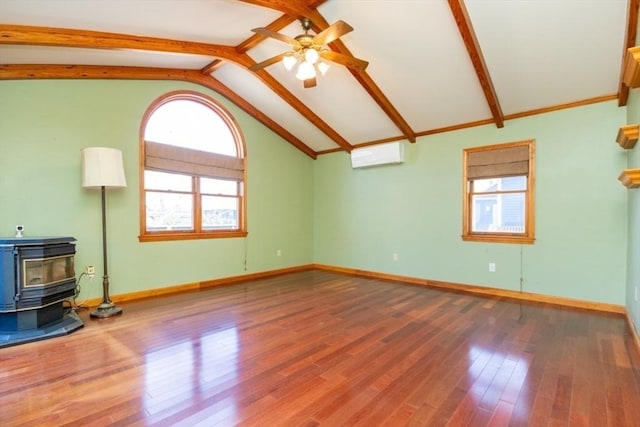 unfurnished living room featuring a wood stove, wood finished floors, a wall unit AC, ceiling fan, and vaulted ceiling with beams