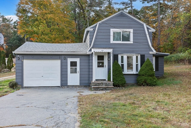 front facade featuring a front yard and a garage