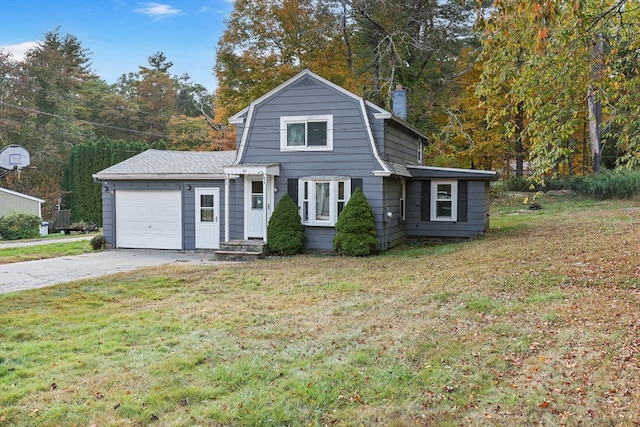 view of property featuring a garage and a front lawn