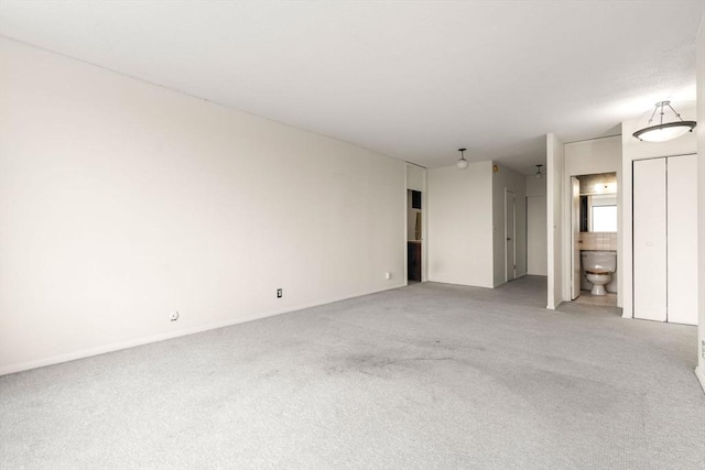 85 E India Row Unit 31D, Boston, MA 02110 - unfurnished living room featuring light colored carpet and baseboards