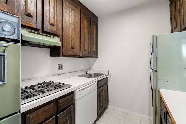 85 E India Row Unit 31D, Boston, MA 02110 - kitchen with white appliances, under cabinet range hood, a sink, and dark brown cabinets