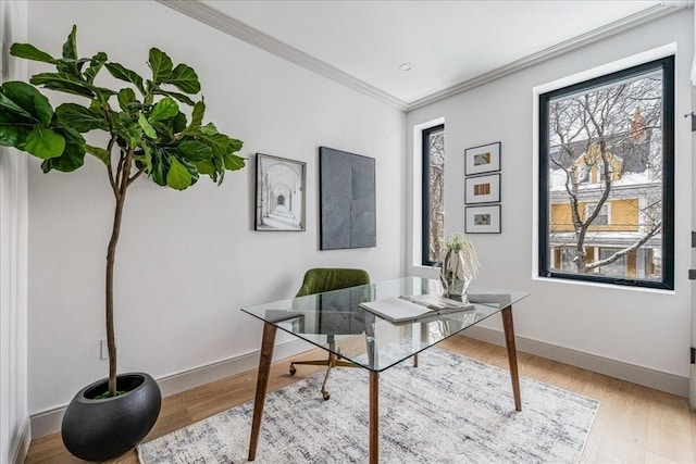 office area with crown molding and light wood-type flooring