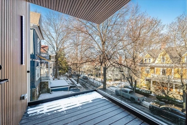 view of snow covered back of property