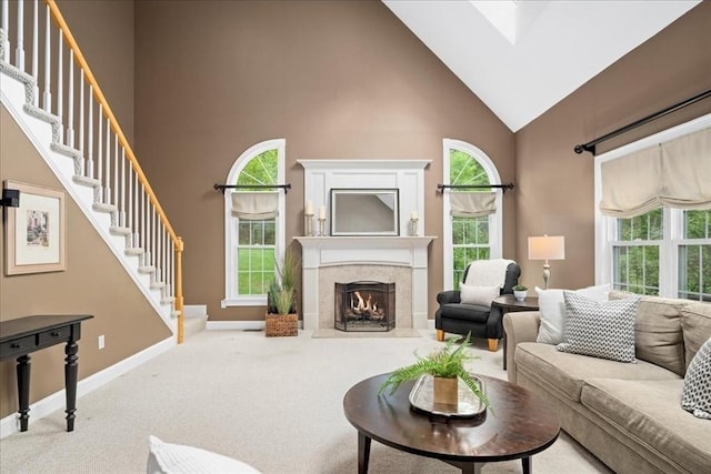 17 Fiddleneck Ln, Southborough, MA 01772 - carpeted living room featuring high vaulted ceiling, baseboards, stairway, and a fireplace with flush hearth