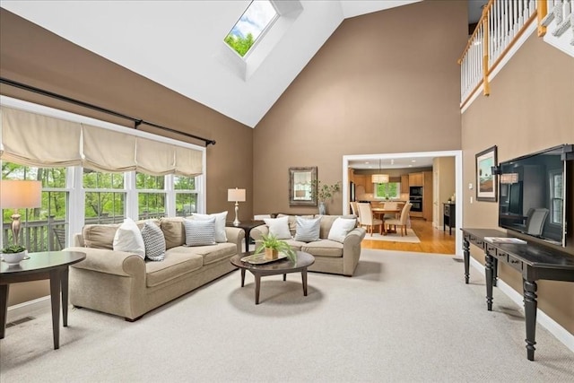 17 Fiddleneck Ln, Southborough, MA 01772 - carpeted living room featuring high vaulted ceiling, a skylight, and baseboards