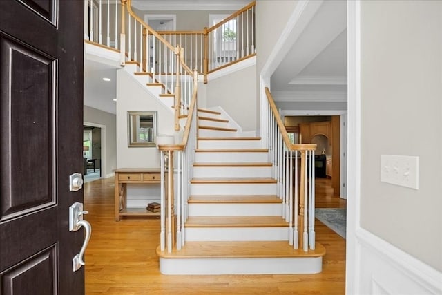 17 Fiddleneck Ln, Southborough, MA 01772 - entrance foyer with light wood-style floors, crown molding, stairs, healthy amount of natural light, and a high ceiling