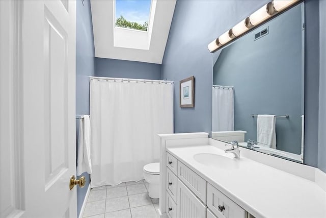 17 Fiddleneck Ln, Southborough, MA 01772 - bathroom featuring a skylight, toilet, tile patterned flooring, vanity, and lofted ceiling