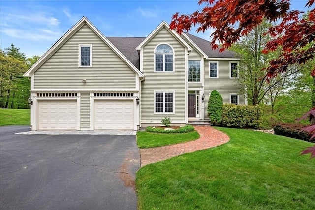 17 Fiddleneck Ln, Southborough, MA 01772 - view of front of house with asphalt driveway, a garage, and a front yard
