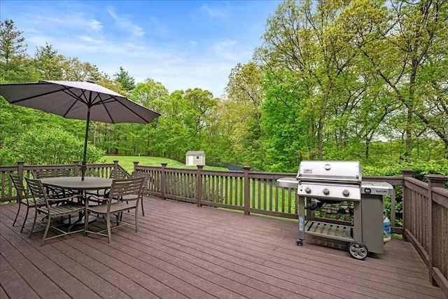 17 Fiddleneck Ln, Southborough, MA 01772 - wooden terrace featuring a shed, outdoor dining area, a yard, and an outdoor structure