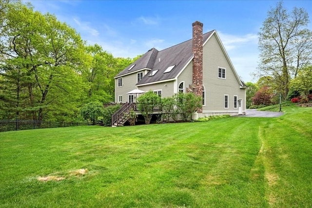 17 Fiddleneck Ln, Southborough, MA 01772 - back of house featuring stairs, a wooden deck, and a chimney