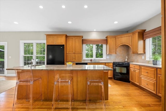 17 Fiddleneck Ln, Southborough, MA 01772 - kitchen with black appliances, a sink, plenty of natural light, light wood-type flooring, and recessed lighting