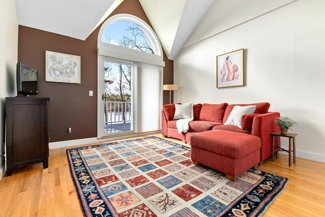 living room featuring hardwood / wood-style floors and high vaulted ceiling