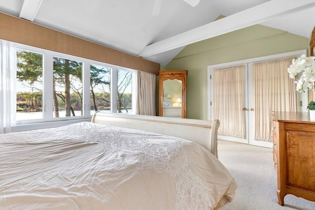 bedroom with ceiling fan, light colored carpet, lofted ceiling, and multiple windows