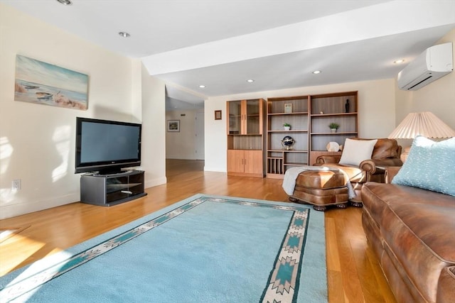 living room with wood-type flooring and an AC wall unit