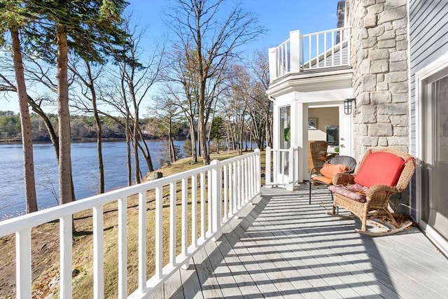 wooden terrace featuring a water view