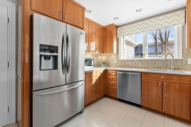 kitchen with decorative backsplash, appliances with stainless steel finishes, and sink