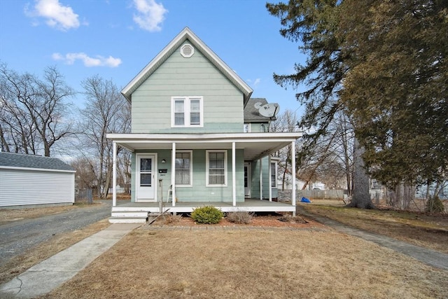 view of front of house with a porch and a front yard