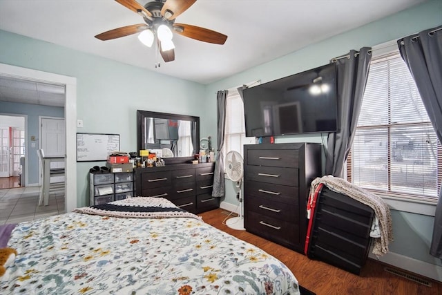 bedroom with multiple windows and ceiling fan