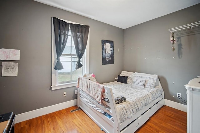 bedroom with hardwood / wood-style flooring