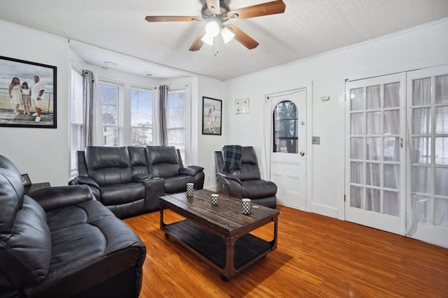 living room featuring wood-type flooring and ceiling fan