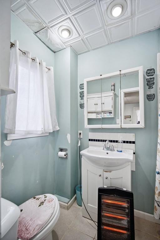 bathroom with tile patterned floors, vanity, toilet, and backsplash