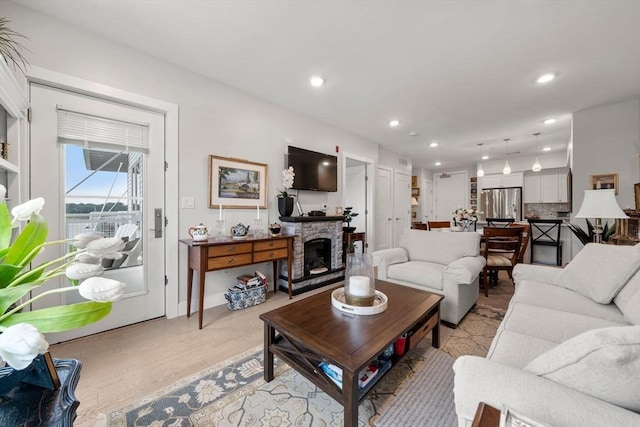 130 Broad Reach Unit 302, Weymouth, MA 02191 - living area featuring a fireplace, recessed lighting, and light wood-style floors