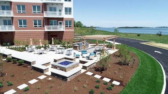 130 Broad Reach Unit 302, Weymouth, MA 02191 - view of community featuring an outdoor fire pit, a pergola, and a water view