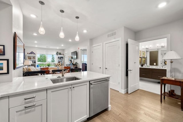 130 Broad Reach Unit 302, Weymouth, MA 02191 - kitchen with stainless steel dishwasher, light wood finished floors, open floor plan, light stone counters, and recessed lighting