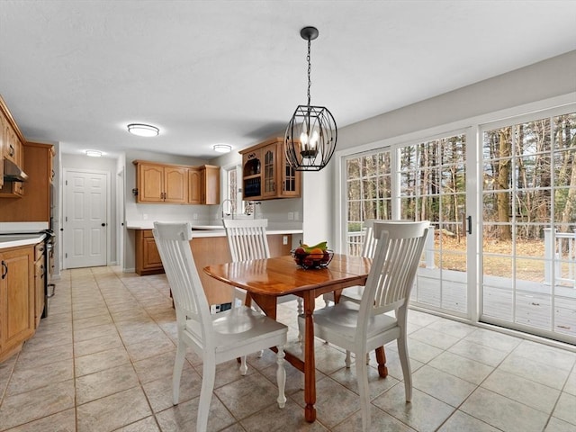 dining area with light tile patterned floors and a chandelier