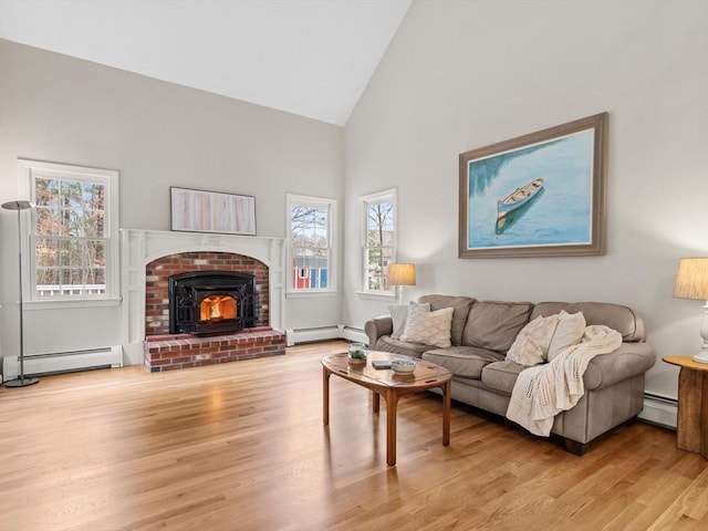 living area featuring wood finished floors, baseboard heating, and high vaulted ceiling