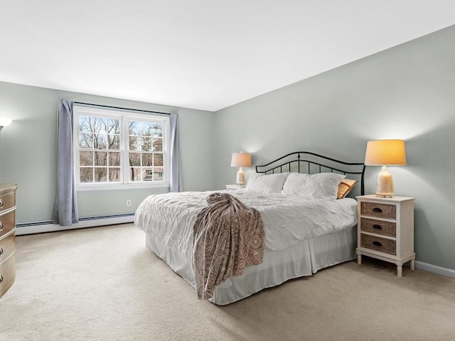 carpeted bedroom featuring baseboard heating and baseboards