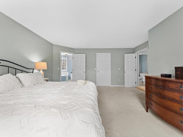 bedroom with baseboards and light colored carpet